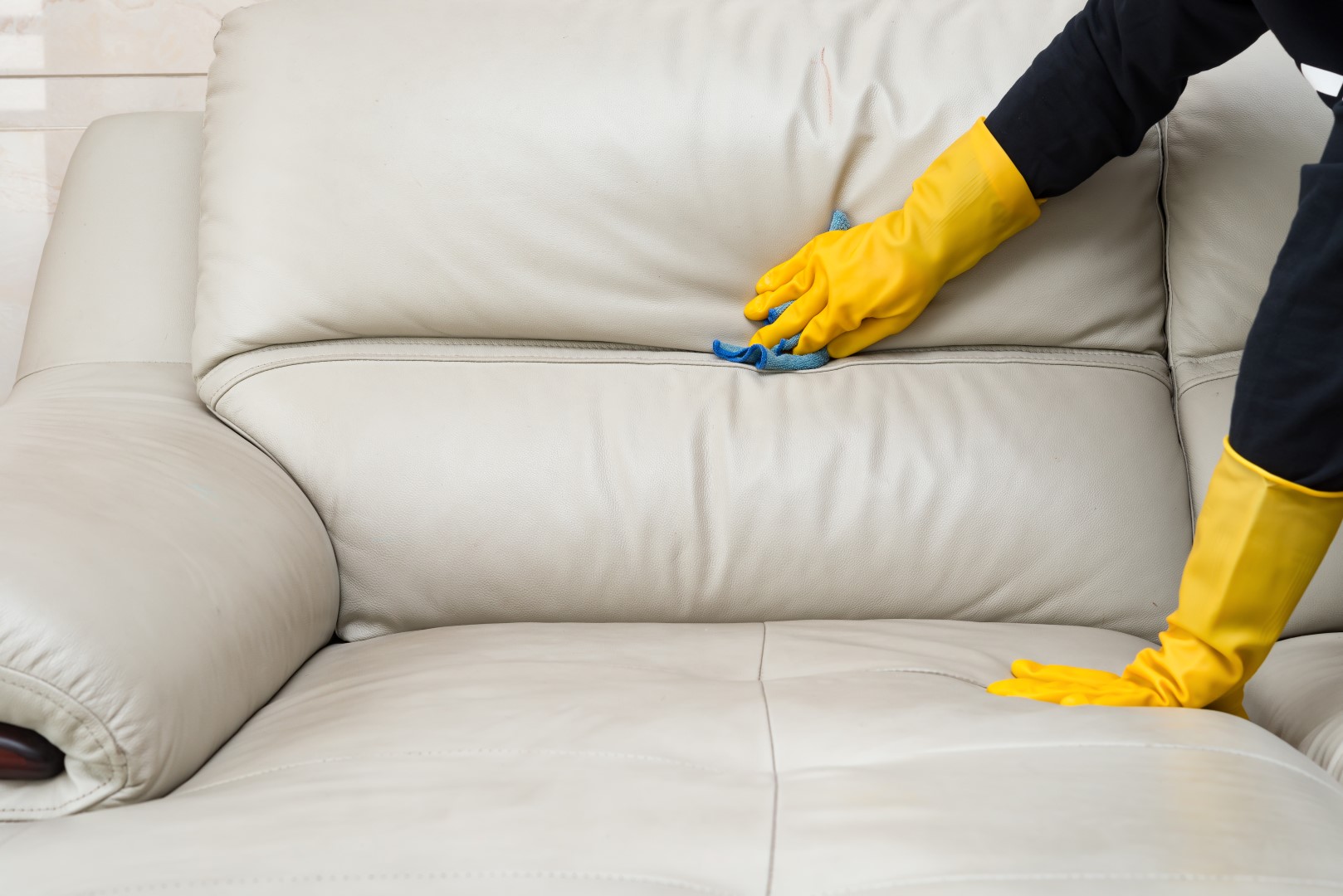 Photograph performing maintenance on a leather sofa